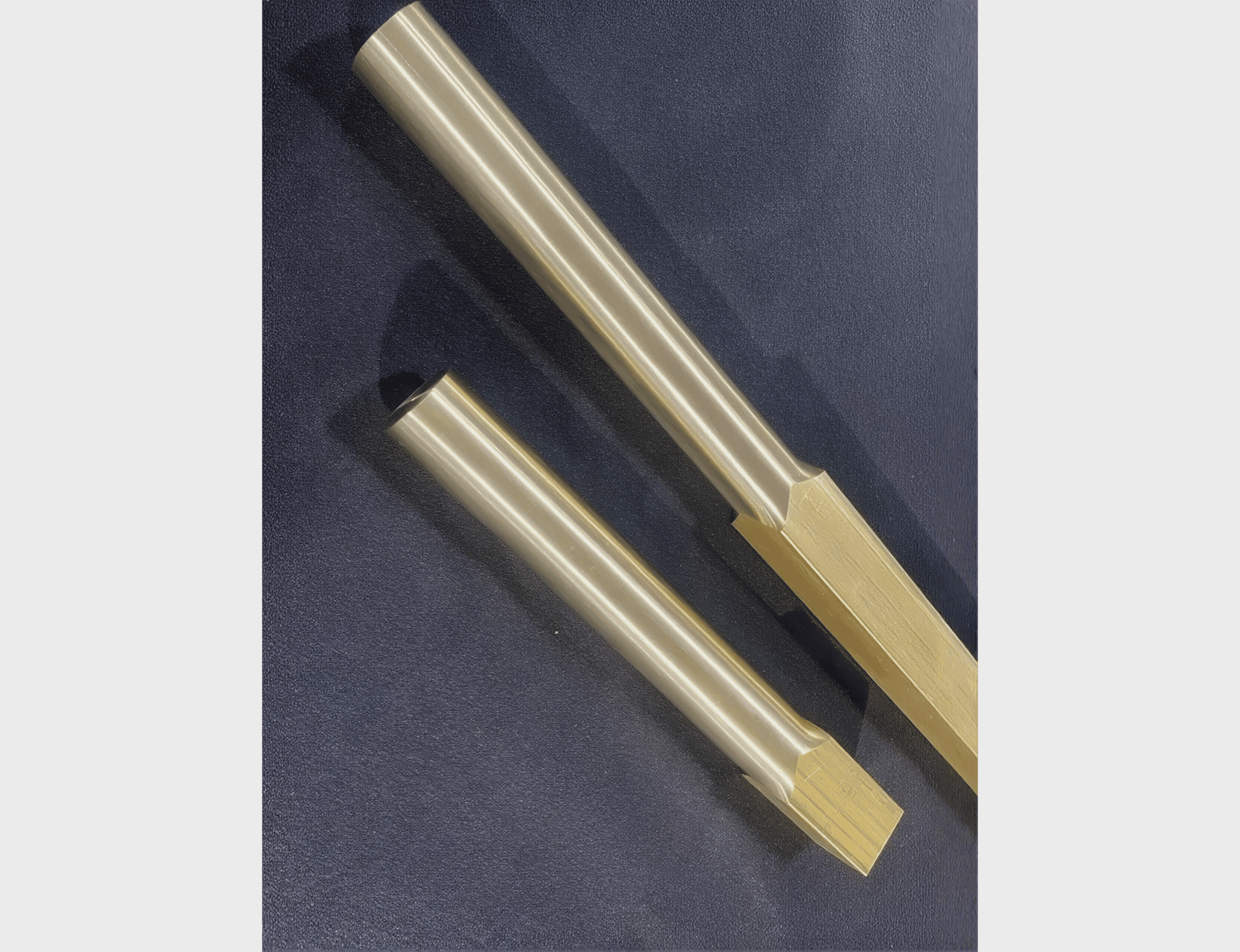 Two metallic cylindrical tools on surface.