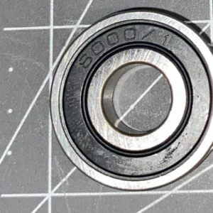 Metal ball bearing on measurement grid background.